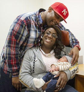 Latarcha and Ivan Mosley with their baby Jeremiah. Photo by Jonathan Sperling.